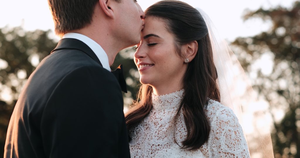 wedding videography man kissing woman on forehead - paros films